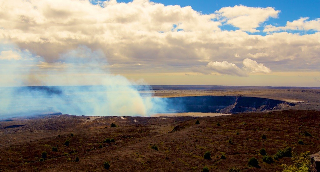 The Halemaumau Overlook Vent smoking away on Kilauea Thursday morning, January 1, 2015. With the mild morning temperature and winds from the Southeast the fumes were pushing North over the landscape instead of rising straight up. Photo by Baron Sekiya